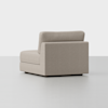 A modern, light beige sectional sofa chair with clean lines and a low back, shown on a plain white background. The chair is positioned at an angle, highlighting its side and back.