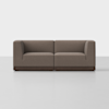 A modern, brown, two-seater sofa with boxy armrests and a dark wooden base, set against a plain white background.
