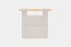 A rectangular light gray felt organizer with two pockets, hanging from a horizontal wooden rod against a plain white background.