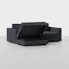 A modern dark gray sectional sofa with one seat lifted to reveal a hidden storage compartment beneath, set against a plain light background.