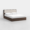 A modern bed with a dark wooden frame and a beige upholstered headboard, neatly made with white sheets, pillows, and a white blanket, set against a plain white background.