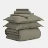 A neatly stacked olive green bedding set, including two pillowcases, a duvet cover, a folded flat sheet, a fitted sheet, and a folded comforter, all displayed against a plain white background.