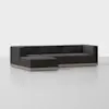 A modern, dark gray L-shaped sectional sofa with low wooden base on a light gray floor against a plain white background.