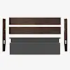 Five unassembled parts of a bed frame are displayed on a white background, including two wooden side panels, two wooden horizontal rails, and a rectangular upholstered gray headboard.