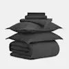 A neatly folded dark gray bedding set including a duvet, two pillowcases, a fitted sheet, and two flat sheets, stacked on a plain white background.