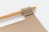 A close-up of a beige felt banner with a stitched loop hanging on a smooth wooden dowel against a white background.