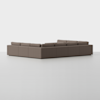 A large, L-shaped sectional sofa upholstered in brown fabric is set against a plain white background. The sofa has clean lines, low arms, and backrests, creating a modern, minimalist appearance.