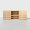 A light wood sideboard with six drawers on each side and three open shelves in the center, set against a plain white background.