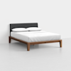 A modern bed with a dark upholstered headboard, wooden frame, white mattress, and two white pillows, placed in a minimalist, light-colored room.