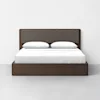 A modern wooden bed frame with a dark brown finish, featuring a rectangular upholstered headboard and two white pillows, neatly made with a white sheet, set against a plain white wall.