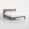 A minimalist wooden bed frame with a rectangular headboard, dressed in white bedding and two white pillows, set against a plain white background.