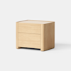 A wooden nightstand with two drawers, featuring smooth edges and a light natural finish, placed on a light gray surface against a plain white background.