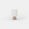 A cylindrical table lamp with a beige base and a light-colored fabric shade.
