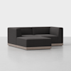 A modern, L-shaped sectional sofa with dark charcoal upholstery and a light wooden base, set against a plain white background.