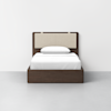 A modern twin bed with a dark wooden frame, beige upholstered headboard, and white bedding, including a pillow and neatly made sheets, set against a plain white wall and light gray floor.
