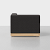 A modern black upholstered sofa with a low wooden base, shown from the side against a plain light gray background.