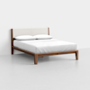A modern wooden bed frame with a light fabric upholstered headboard, neatly made with white sheets and two white pillows, set against a plain white background.