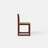 Side view of a simple, modern wooden chair with a straight backrest and seat, set against a plain white background.