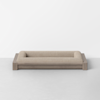 A modern, rectangular pet bed with a light wood frame and beige upholstered cushion, placed against a plain white wall on a light gray floor.