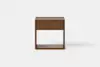 A modern wooden nightstand with a single drawer and an open lower shelf, shown against a plain white background.