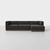 A modern, dark gray sectional sofa with a wooden base, featuring three seats and a right-facing chaise lounge, placed in a minimal, light-colored room.
