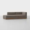 A modern sectional sofa with brown upholstery and a wooden base, featuring a low back and an extended chaise lounge on the left, set against a plain white background.
