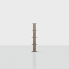 A wooden vertical bookcase with five staggered shelves stands alone on a light, empty floor against a plain white background.