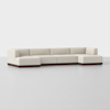 A modern, low-profile sectional sofa with cream-colored upholstery and a dark wooden base, displayed against a plain light background. The sofa has clean lines and an L-shaped design.