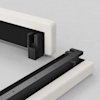 Two upholstered bed frame sections with exposed black metal connectors and brackets on a light surface, positioned to show how the pieces join together.