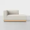 A modern, minimalist light beige chaise lounge with a low backrest and wooden base, set against a plain white background.