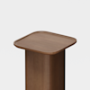 A wooden pedestal with a smooth, rounded square top and a cylindrical base, set against a plain white background.