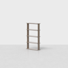A wooden bookshelf with four shelves stands on a light gray, empty floor against a plain white background. The shelf has a simple, modern design with a natural wood finish.
