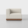 A modern, cream-colored upholstered corner sofa seat with a wooden base, positioned on a light gray floor against a plain white background.