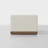 A modern, rectangular, light beige upholstered bench with a smooth texture and a wooden base, positioned against a plain white background.