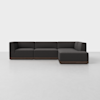 A modern, dark gray L-shaped sectional sofa with clean lines and a low wooden base, set against a plain white background.