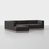 A modern, dark gray L-shaped sectional sofa with a low profile and a light wooden base, set against a plain white background.