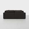 A modern, dark gray sectional sofa with clean lines is shown from the side against a plain white background. The sofa has thick cushions and a minimalist design.