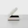 A modern, square, beige ottoman with a hinged top partially open, revealing hidden storage space inside, set against a plain white background.