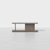 A modern rectangular wooden coffee table with clean lines, a flat top, and a geometric base featuring vertical and horizontal panels in a light wood finish, placed on a seamless light gray surface.
