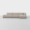 A modern, beige sectional sofa with a low back and clean lines, arranged in an L-shape on a light-colored floor against a plain white background.
