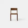 A simple, modern wooden chair with a flat seat, straight legs, and a rectangular backrest, positioned against a plain white background.