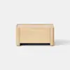 A simple, rectangular wooden box with light wood grain, placed on a light gray surface against a plain white background.