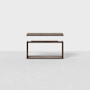 A modern, minimalist wooden side table with a rectangular top and open rectangular frame, shown against a plain white background. The tables top appears to be floating just above the base.