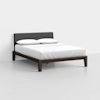 A modern bed with a dark wood frame, white bedding, two pillows, and a dark gray upholstered headboard, set against a plain light-colored background.