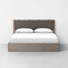 A modern wooden bed with a brown upholstered headboard, neatly made with white bedding and two white pillows, set against a plain white wall on a light gray floor.