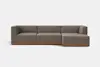 A modern, L-shaped sectional sofa with brown fabric upholstery and a wooden base, set against a plain white background.