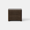 A modern, dark wood nightstand with two drawers, set against a plain white background and floor.
