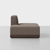 Side view of a modern, armless brown upholstered sofa with a low wooden base, set against a plain white background on a light gray floor.
