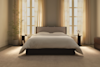 A neatly folded white comforter or duvet with a quilted pattern, displayed on a plain white background.