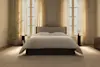 A neatly folded white comforter or duvet with a quilted pattern, displayed on a plain white background.